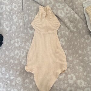 Beige Ribbed turtleneck cropped sweater. top folds down